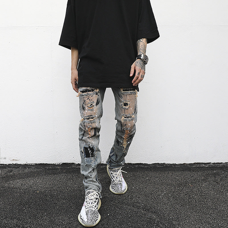 Distressed And Ink-sprayed Small-footed Jeans With Ripped Patches