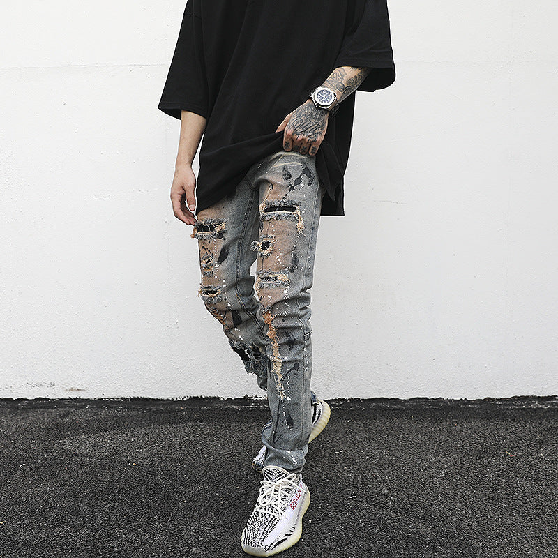 Distressed And Ink-sprayed Small-footed Jeans With Ripped Patches