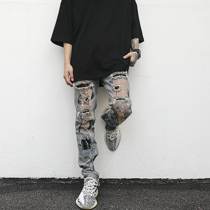 Distressed And Ink-sprayed Small-footed Jeans With Ripped Patches